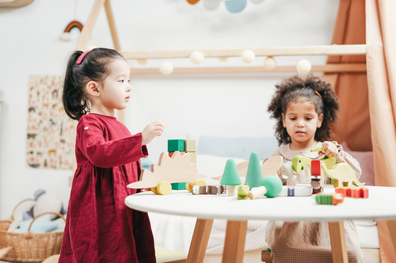 Image of 2 girls playing with blocks
